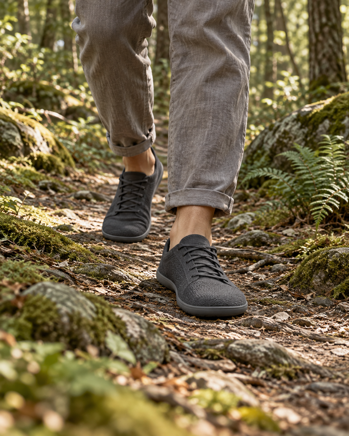 Editorial scene of minimalist footwear on a quiet woodland path